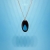 Blue tear in oval pendant